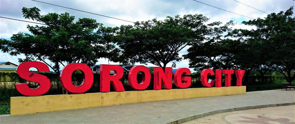 Red Sorong City sign in front of Domine Eduard Osok Airport
