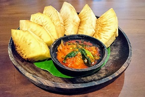 Plate of fried breadfruit with sambal sauce